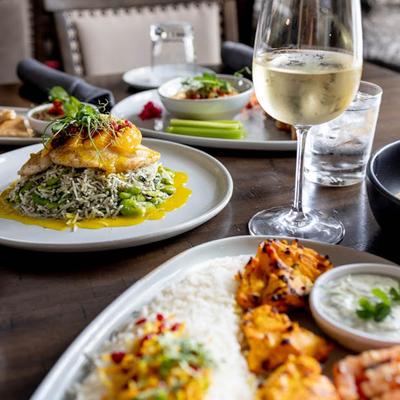 Assorted dishes and wine spread on a table, close up.