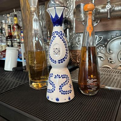 Tequila bottles on bar mat.