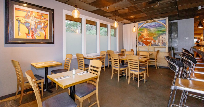 Interior, dining tables and seats, wall mural and and a painting