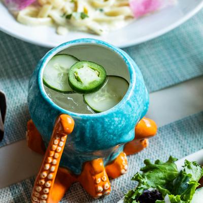 Cocktail served in a mug shaped like an octopus.