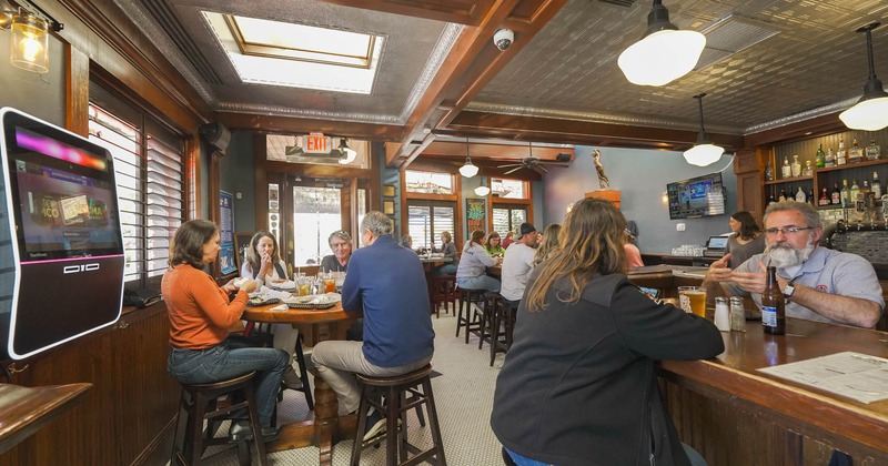 Interior, tables, chairs, counter, people sitting, lights, ceiling and wall windows