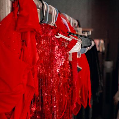Changing room details, a hanger stand with red clothes.