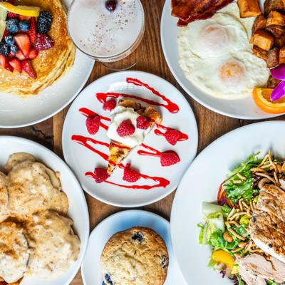 Various breakfast dishes served on the table with a cocktail.