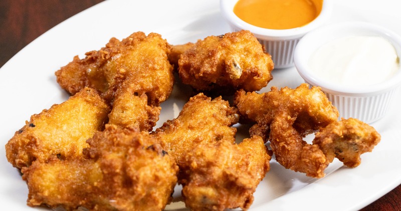 Fried chicken wings served with a dipping sauces