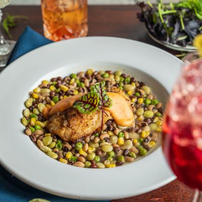 Seared black grouper with beans, corn, and greens.