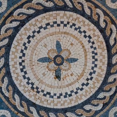 Circular mosaic pattern with a floral motif at the center.