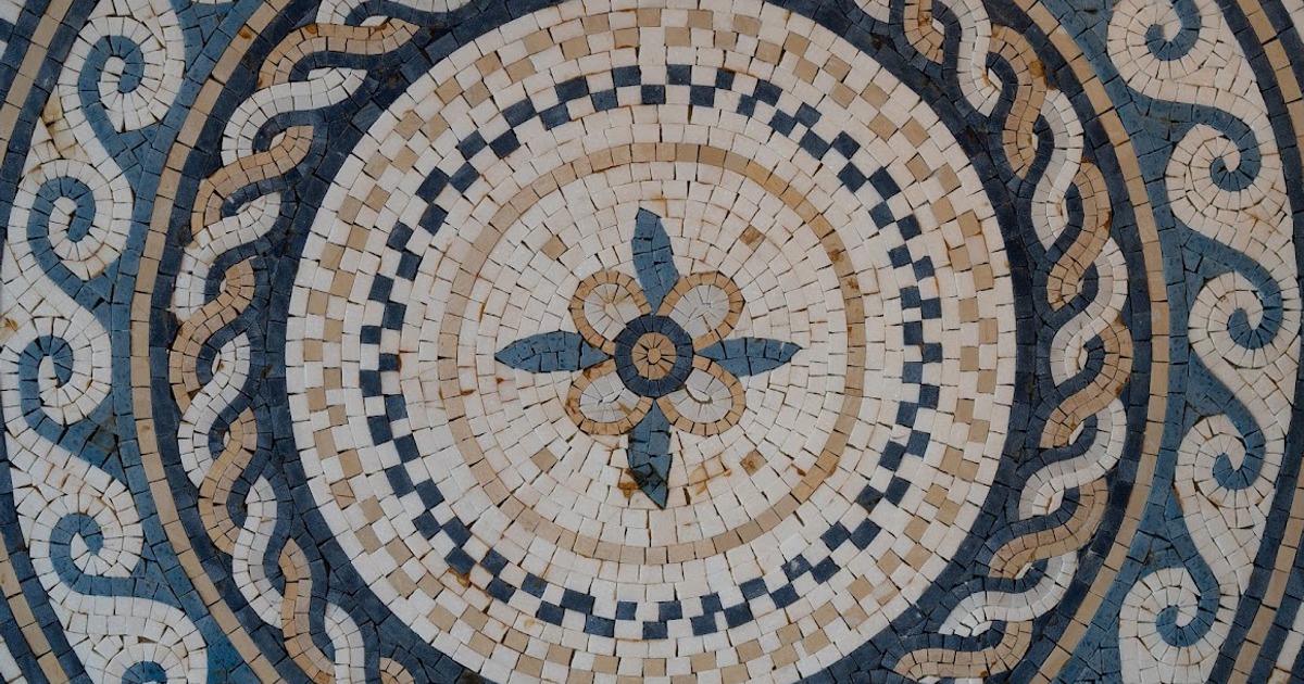 Circular mosaic with a central floral pattern