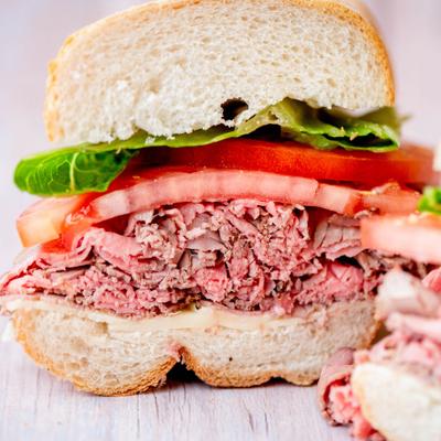Roast beef sandwich with lettuce and tomato.