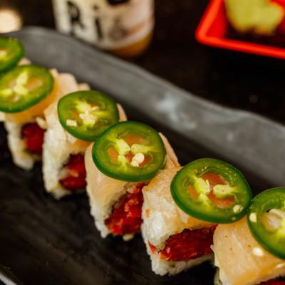 Close-up of Aloha sushi roll topped with jalapeno slices.