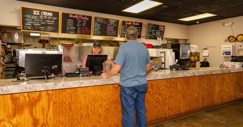 Interior, food counter, guest, screens above