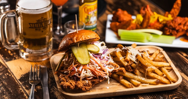 Buttermilk Chicken Sandy, accompanied with fries and a glass of beer