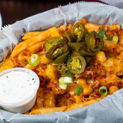 Loaded fries, with melted cheese, jalapenos, bacon, scallions, and dipping sauce.
