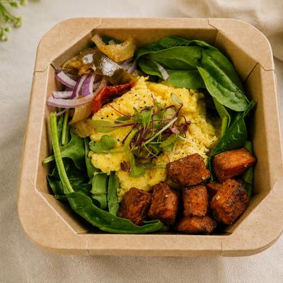 Breakfast Bowl with roasted vegetables, greens, scrambled eggs, and potatoes.