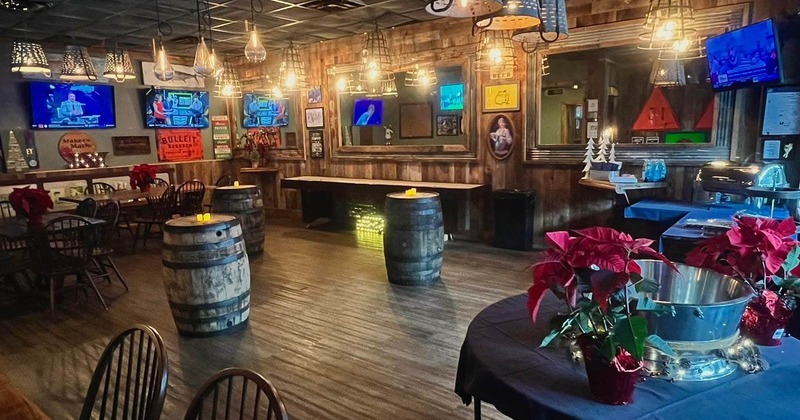 Interior seating area with tables and chairs and two wooden barrel tables