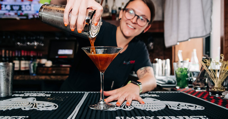 A staff member making cocktails