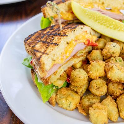 Ham sandwich with a side of fried okra, close up