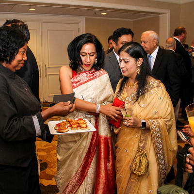 Two stylish women sampling food
