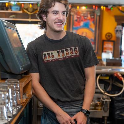 An employee standing by a POS screen.