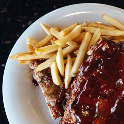 Ribs in BBQ sauce served with fries