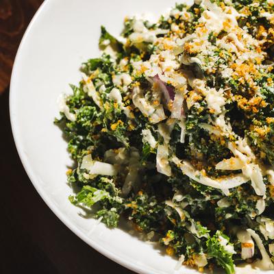 Kale Caesar Salad, with grilled chicken, garlic breadcrumbs, red onion and cheese.