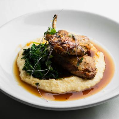 Oven Roasted Chicken with cheddar grits, spinach, and microgreens.