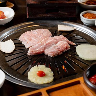 Meat, vegetables, and fruits grilling.