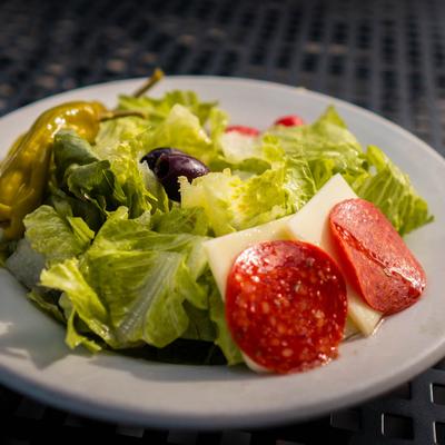 Dinner Salad, with romaine, tomatoes, mozzarella, peppers, pepperoni and olives.