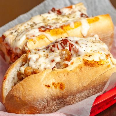 Meatball sub sandwich with melted cheese.