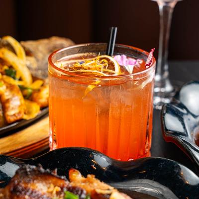 Honey Yuzu drink rests on a table, surrounded by food.