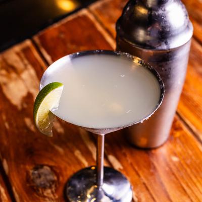 A classic lime margarita cocktail served in a stemmed metallic glass.