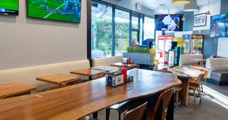 Interior, dining area, high live edge wooden table with stools, regular tables with bench and chairs