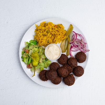 Falafel plate, with rice, veggies, and dipping sauce.