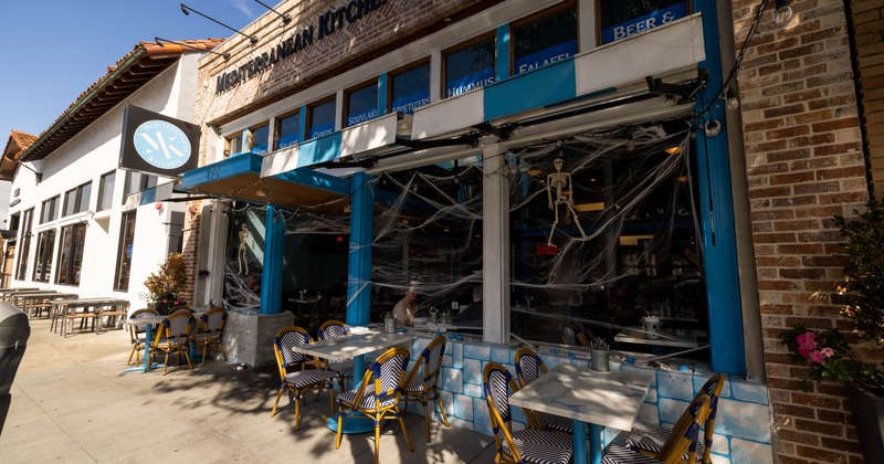 Exterior of Mediterranean Kitchen restaurant with Halloween decorations and outdoor seating