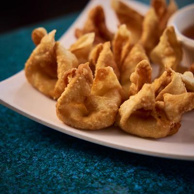 Crab Delight Wontons with a dip on the side, close-up.