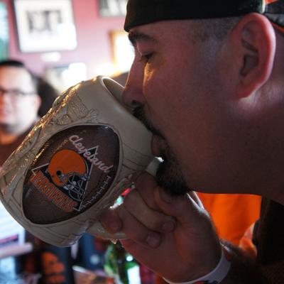 A guy drinking from a mug closeup