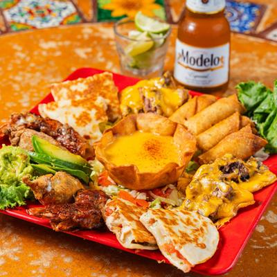 Combo platter, with chicken quesadillas, beef nachos, flautitas, stuffed jalapenos, and cheese dip.
