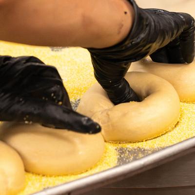 Forming a bagel with dough.