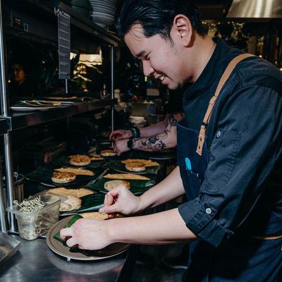 Chef carefully plating dishes.