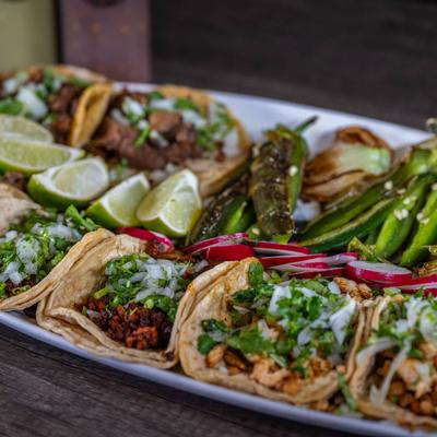 Plate with a variety of tacos.