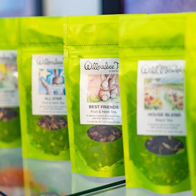 Vibrant green packages of herbal tea blends.