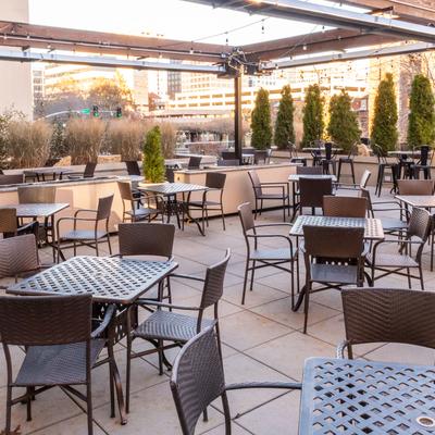 Spacious patio with tables, chairs, and string lights