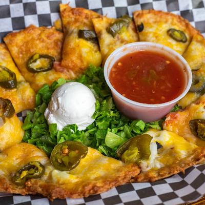 Nachos with cheese, jalapenos, salsa, and sour cream.