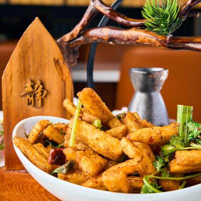 Deep fried eggplant in a bowl with herbs.
