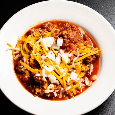 Beef chili, with onions and cheese.