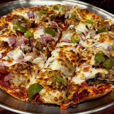 Thin crust pizza with melted cheese, sausage, pepperoni, onions, and green peppers.