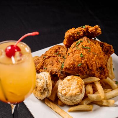 Fried chicken with fries and biscuits, accompanied with a cocktail