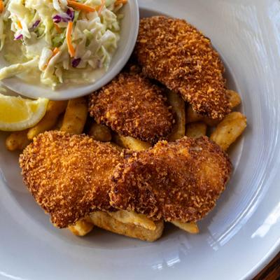 Breaded Arctic cod with fries and coleslaw.