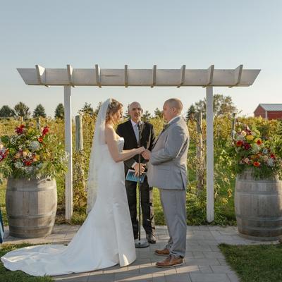 Wedding Couple in front of Wedding arch at Next Chapter Winery.
