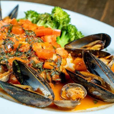 Red Snapper topped with a chunky tomato sauce and garnished with mussels and clams.