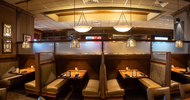 Interior, dining area, booths with padded seating and wooden top tables, large room divider